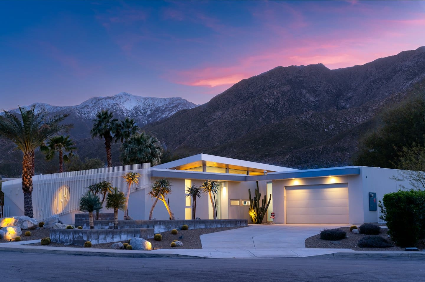 Modern house with desert landscaping at twilight.